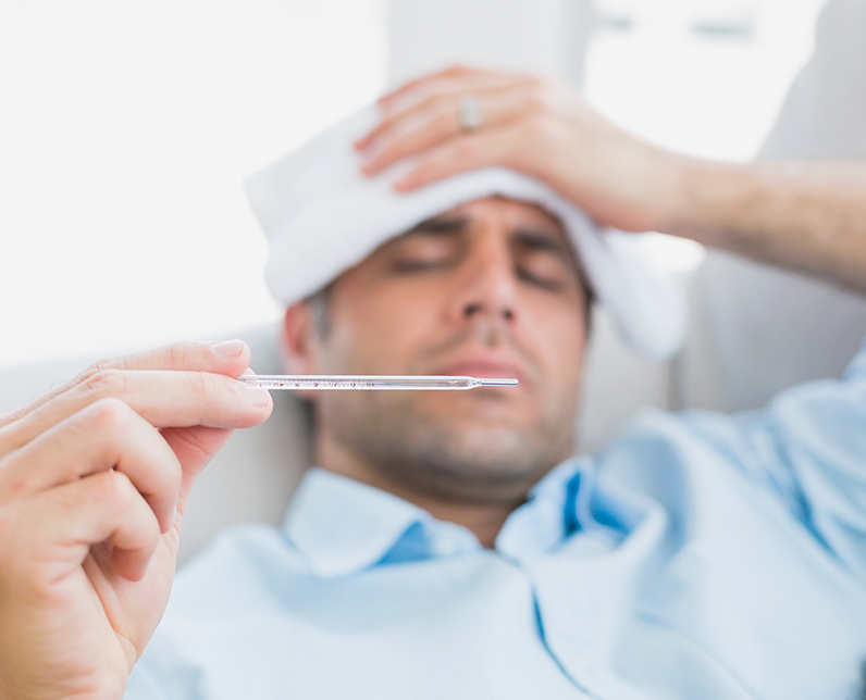 Sick Man Checking Thermometer